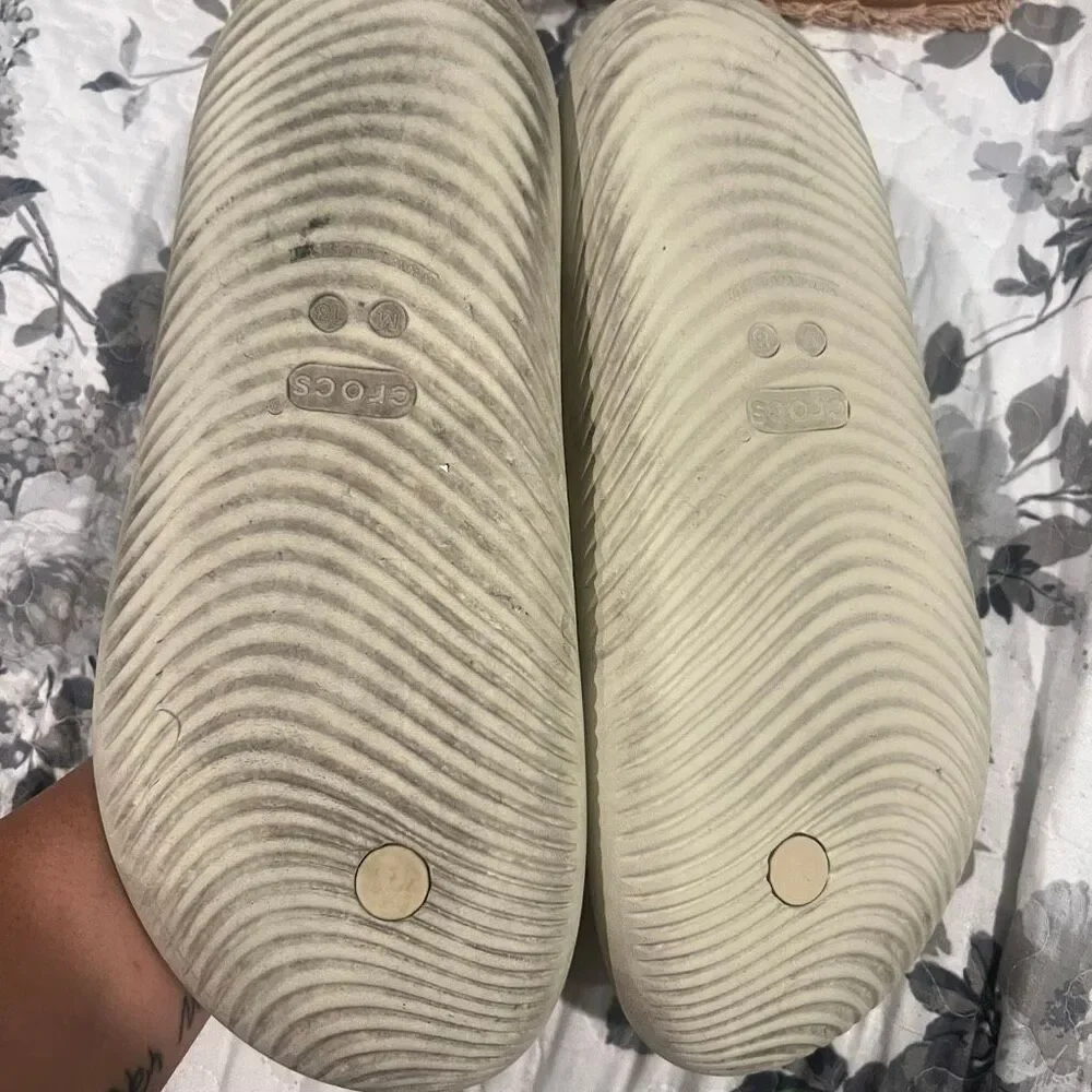 Crocs Mellow Flip sandals feature a thick, comfortable footbed designed for reco